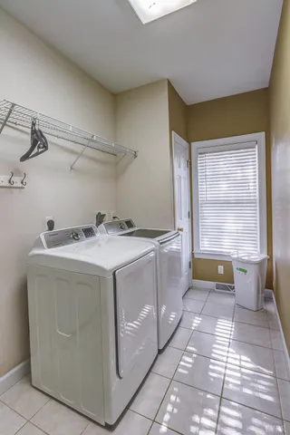 a view of an empty room with a chandelier fan