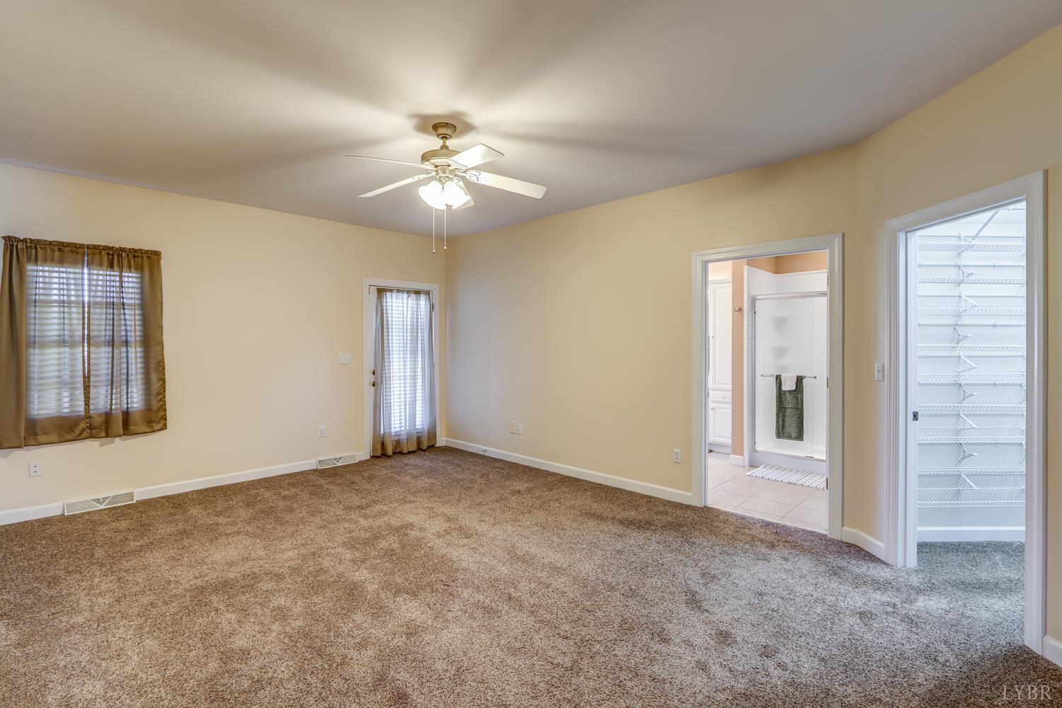 1315 Donnally Road Forest, VA 24551 - Photo 33 of 74 an empty room with chandelier fan and windows