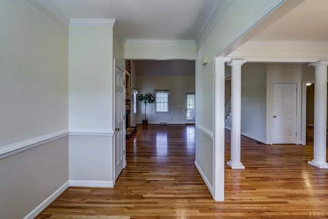 a view of a room with wooden floor and white walls