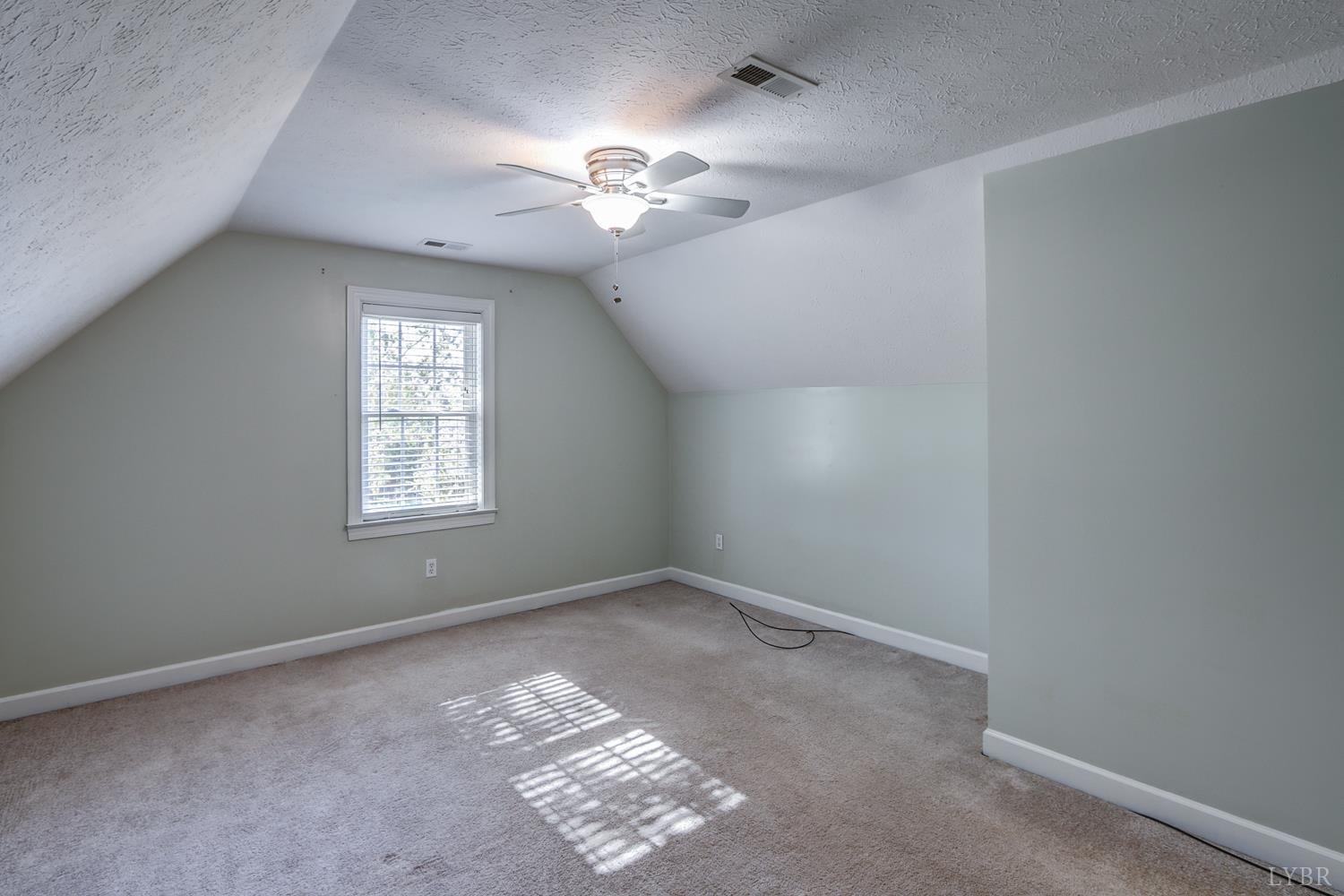 1315 Donnally Road Forest, VA 24551 - Photo 54 of 74 an empty room with windows and chandelier fan