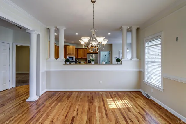 a view of a kitchen with wooden floor and a chandelier