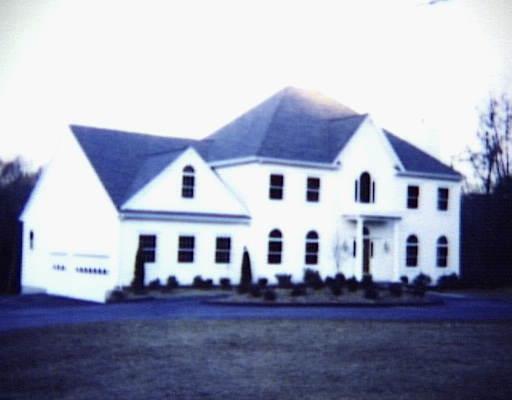 174 Haviland Road Stamford, CT 06903 - Photo 1 of 1 a view of a white house next to a yard with wooden fence