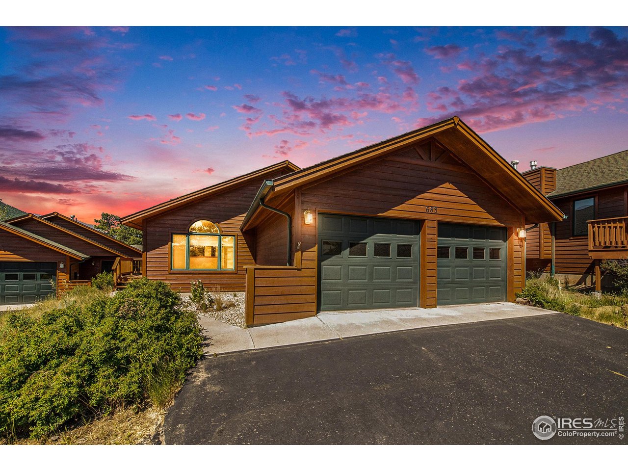 683 Cedar Ridge Circle Estes Park, CO 80517 - Photo 2 of 39 a front view of a house with a garden