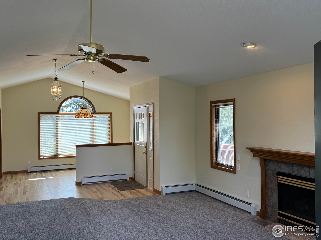 683 Cedar Ridge Circle Estes Park, CO 80517 - Photo 37 of 39 a view of a livingroom with a fireplace a ceiling fan and a window