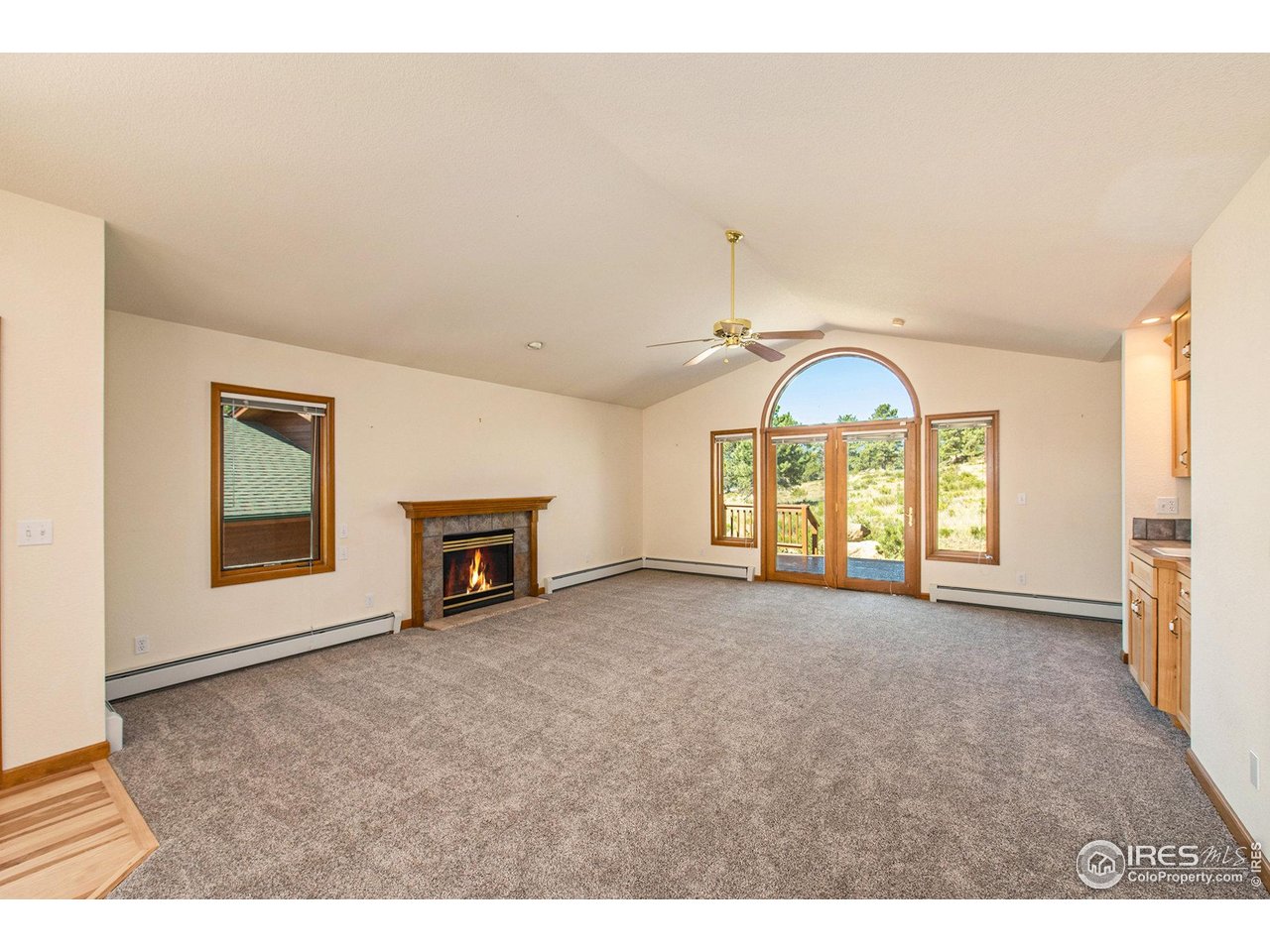 683 Cedar Ridge Circle Estes Park, CO 80517 - Photo 5 of 39 a view of an empty room with a fireplace and a window