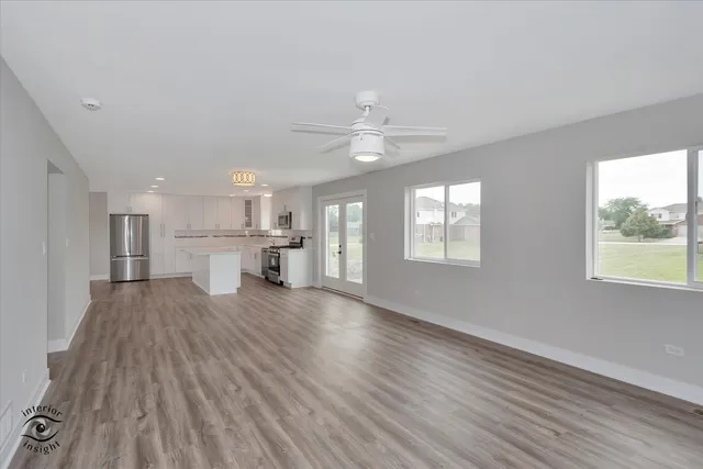 a view of kitchen with livingroom and wooden floor