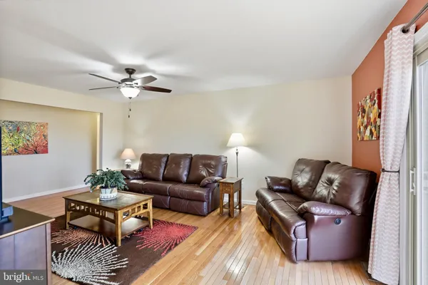 a living room with furniture and a lamp