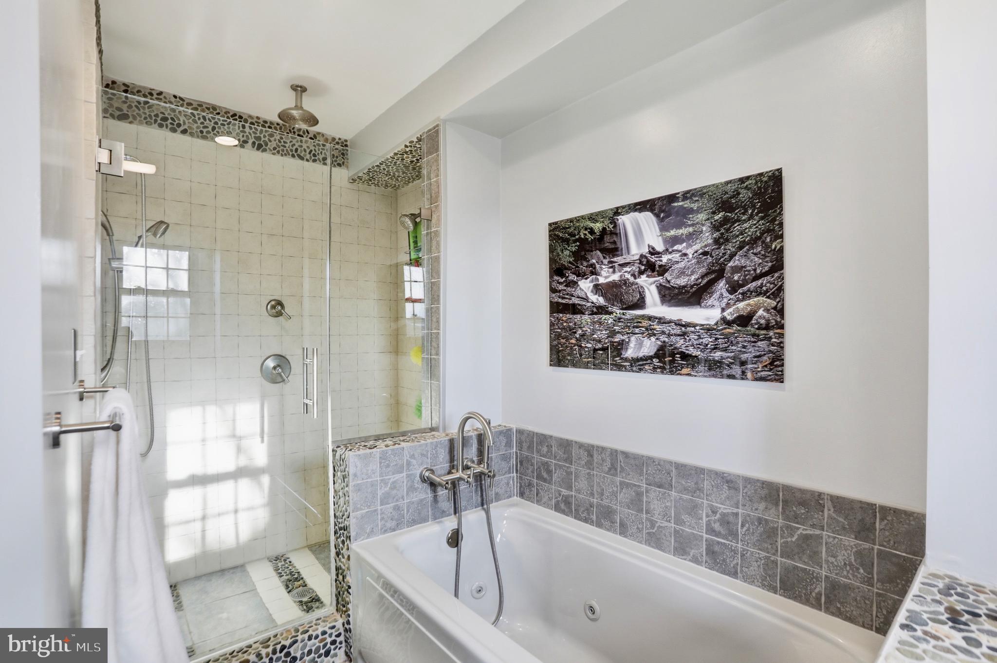 4708 Summit Point Road Charles Town, WV 25414 - Photo 18 of 49 a bathroom with a bathtub and shower