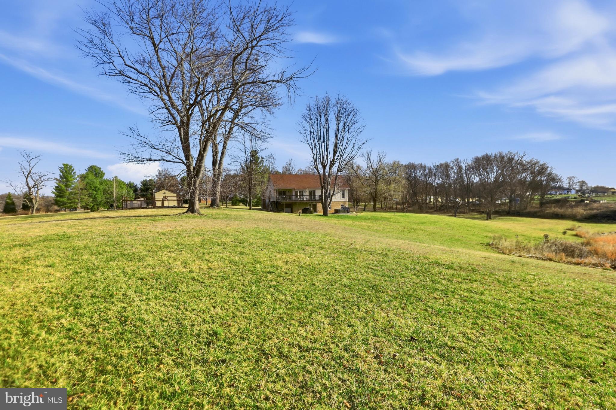 4708 Summit Point Road Charles Town, WV 25414 - Photo 35 of 49 a view of a field with an trees in front of it