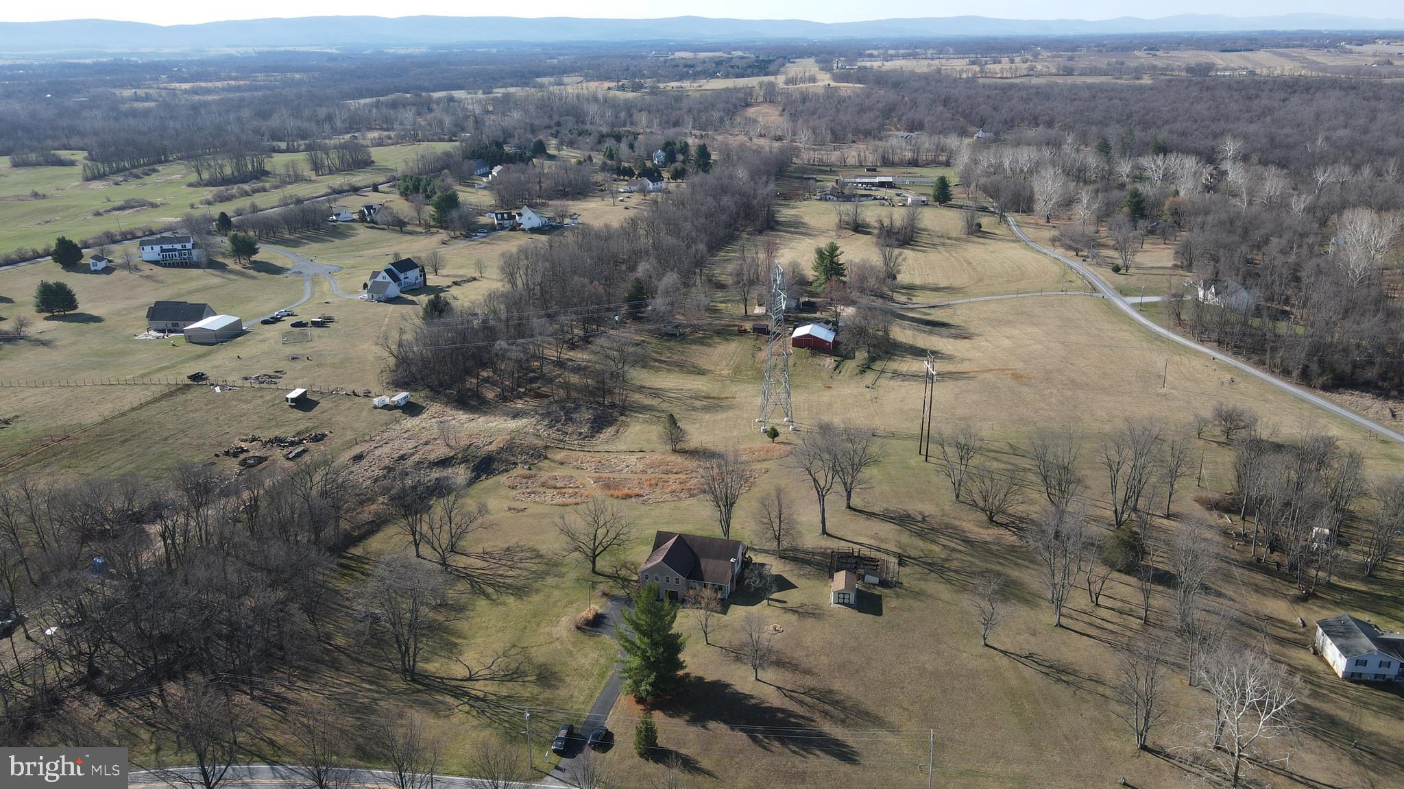 4708 Summit Point Road Charles Town, WV 25414 - Photo 39 of 49 an aerial view of house with yard and mountain view in back
