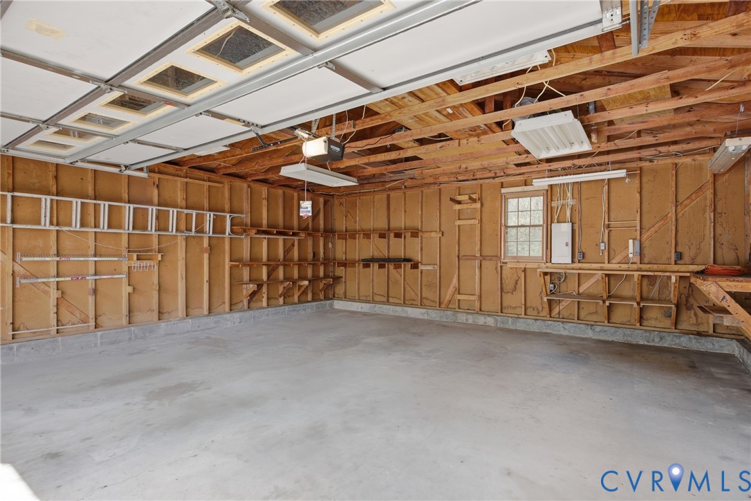 9832 Alfaree Road Richmond, VA 23237 - Photo 35 of 35 Garage with electric panel and a garage door opene