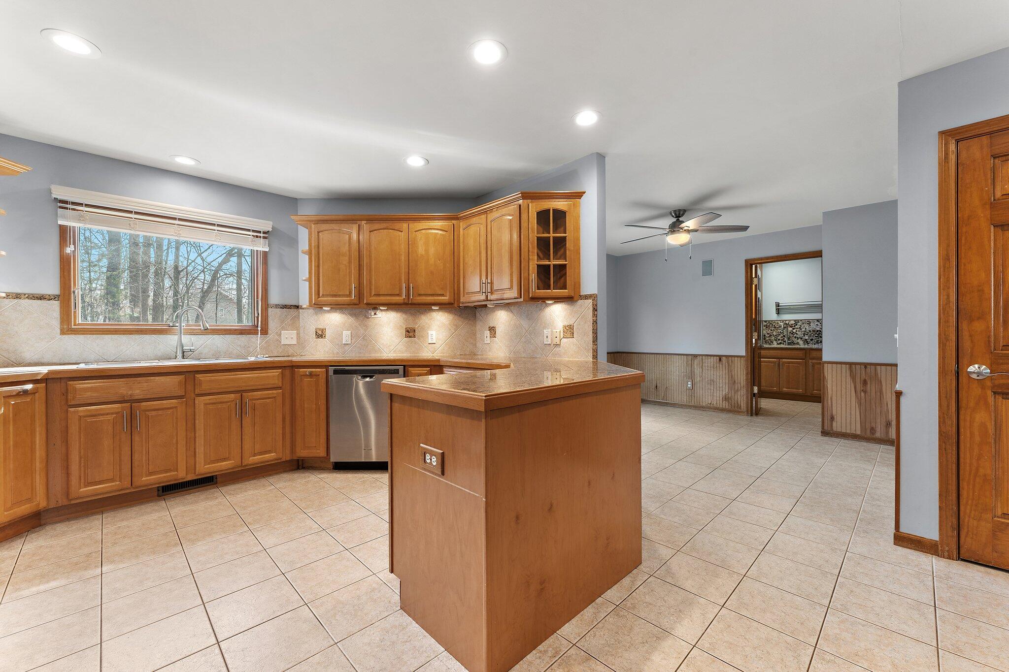 437 Lost Tree Drive Chesterton, IN 46304 - Photo 8 of 43 a kitchen with stainless steel appliances granite countertop a refrigerator and a sink
