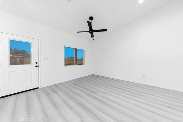 a view of a room with wooden floor and white walls
