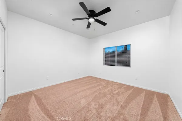 a bathroom with a toilet a sink a vanity and mirror