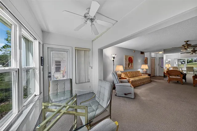 a living room with furniture a flat screen tv and next to a window