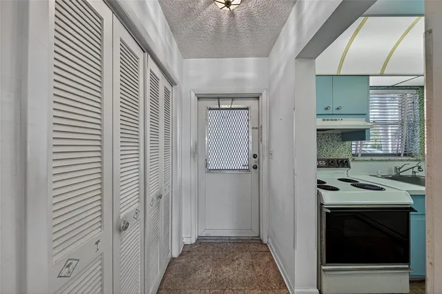 a kitchen with a refrigerator and a stove