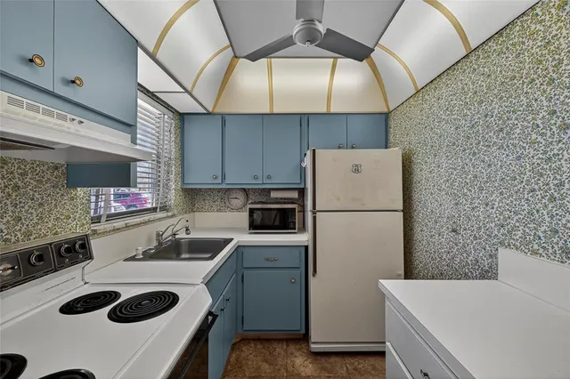 a kitchen with a stove and a refrigerator