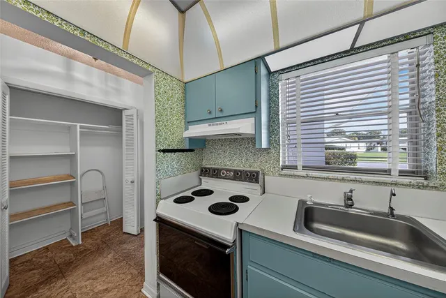 a bedroom with a large bed and wooden floor