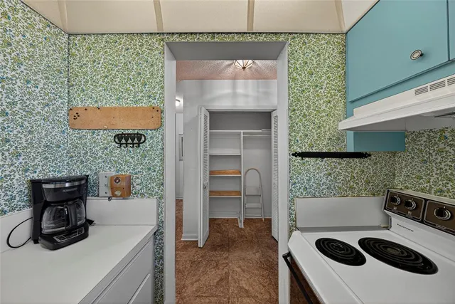 a bedroom with a large bed and wooden floor