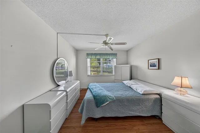 a bedroom with a large bed mirror and a chandelier