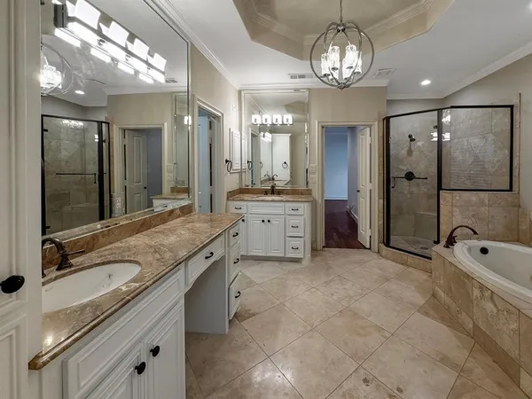 a spacious bathroom with a granite countertop sink a mirror and a shower