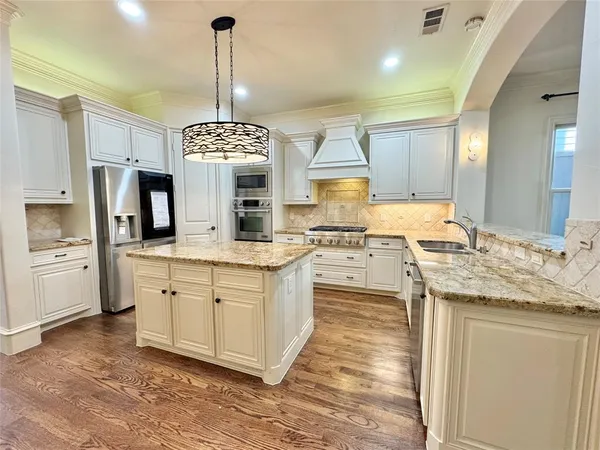 a kitchen with granite countertop a sink cabinets and window