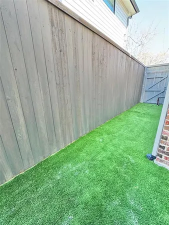 a view of backyard with wooden fence