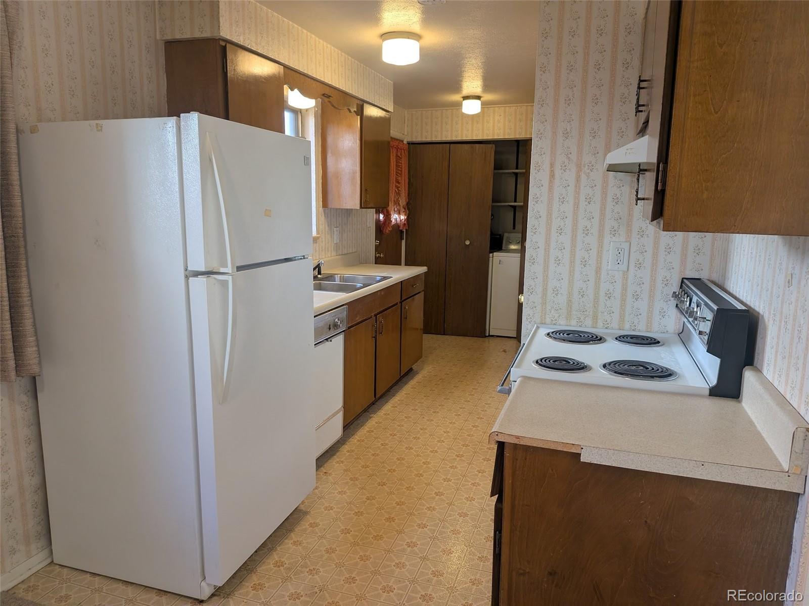 4643 Independence Street, Unit 9 Wheat Ridge, CO 80033 - Photo 4 of 11 a white refrigerator freezer sitting inside of a kitchen