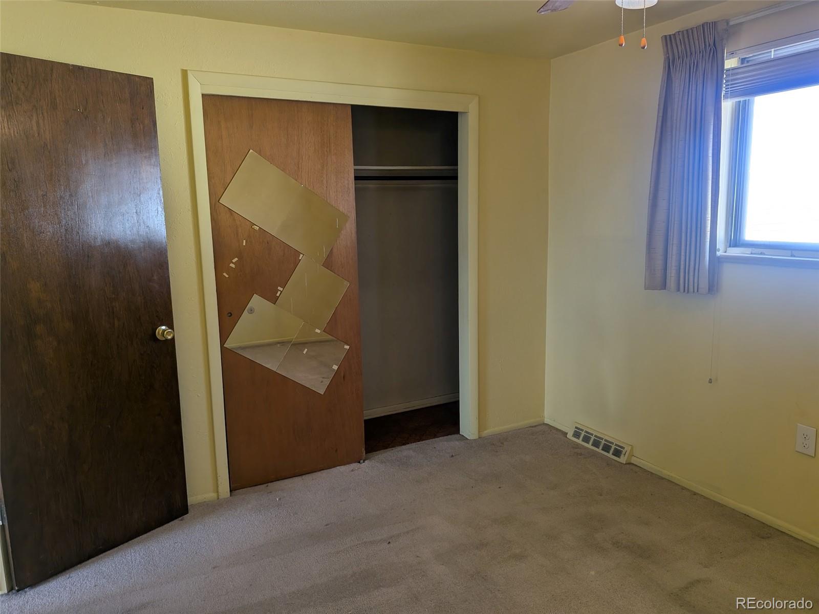 4643 Independence Street, Unit 9 Wheat Ridge, CO 80033 - Photo 8 of 11 an empty room with windows