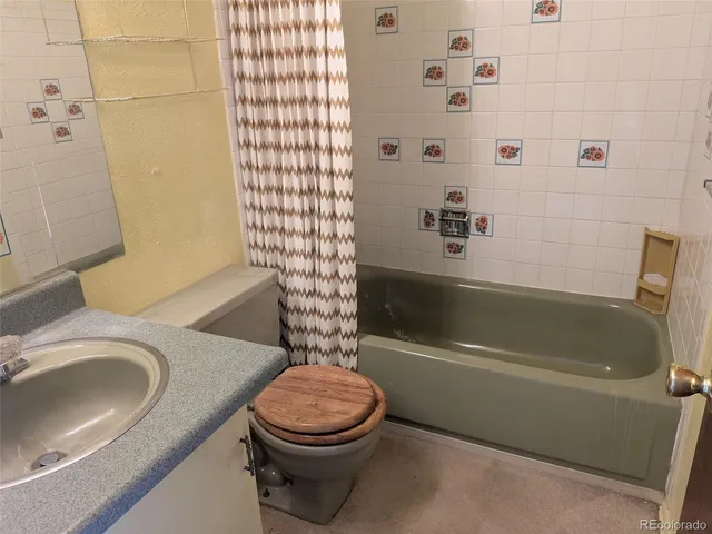 a bathroom with a sink a toilet and bathtub