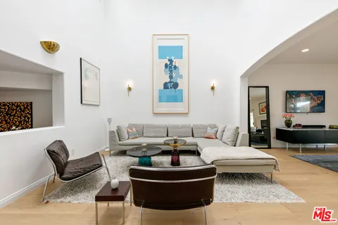 a living room with furniture and a lamp