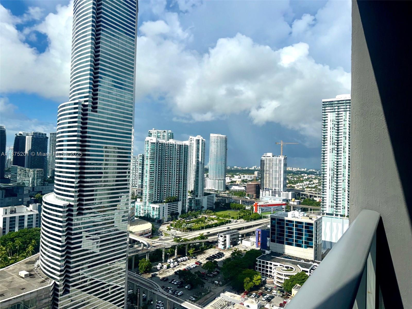151 Southeast 1st Street, Unit 2807 Miami, FL 33131 - Photo 13 of 24 a view of balcony with a potted plant and outdoor seating