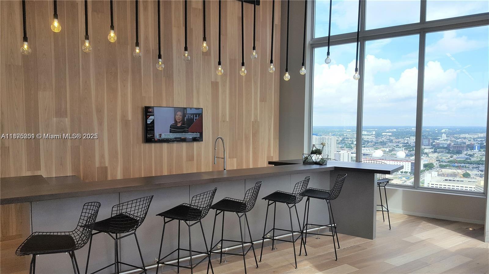 151 Southeast 1st Street, Unit 2807 Miami, FL 33131 - Photo 17 of 24 a kitchen with a table chairs and window