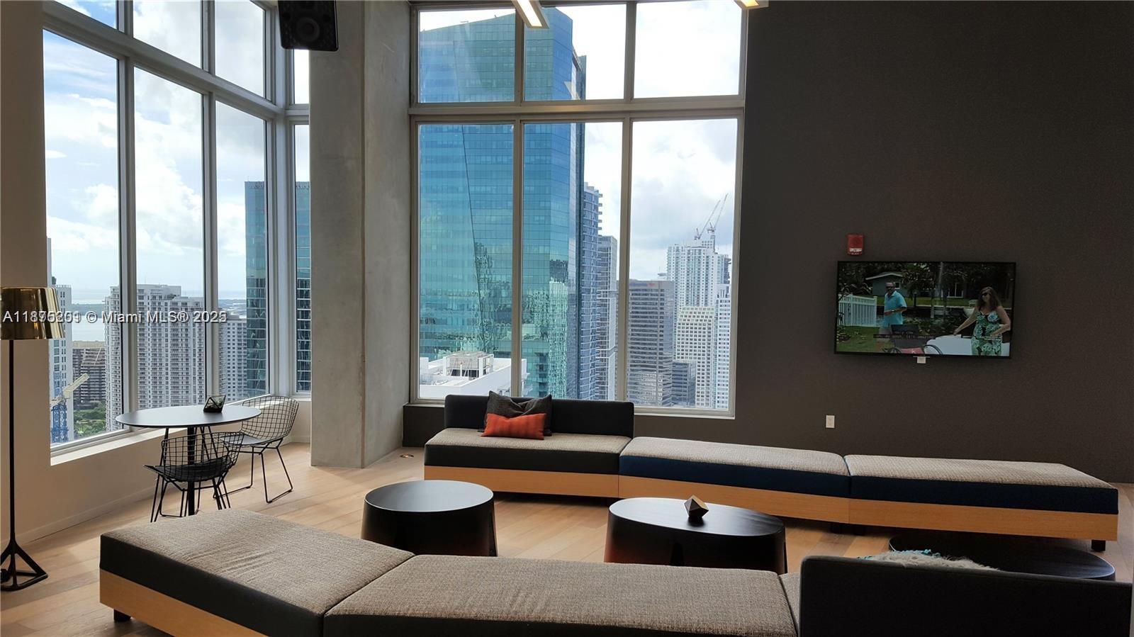 151 Southeast 1st Street, Unit 2807 Miami, FL 33131 - Photo 18 of 24 a living room with furniture and a large window