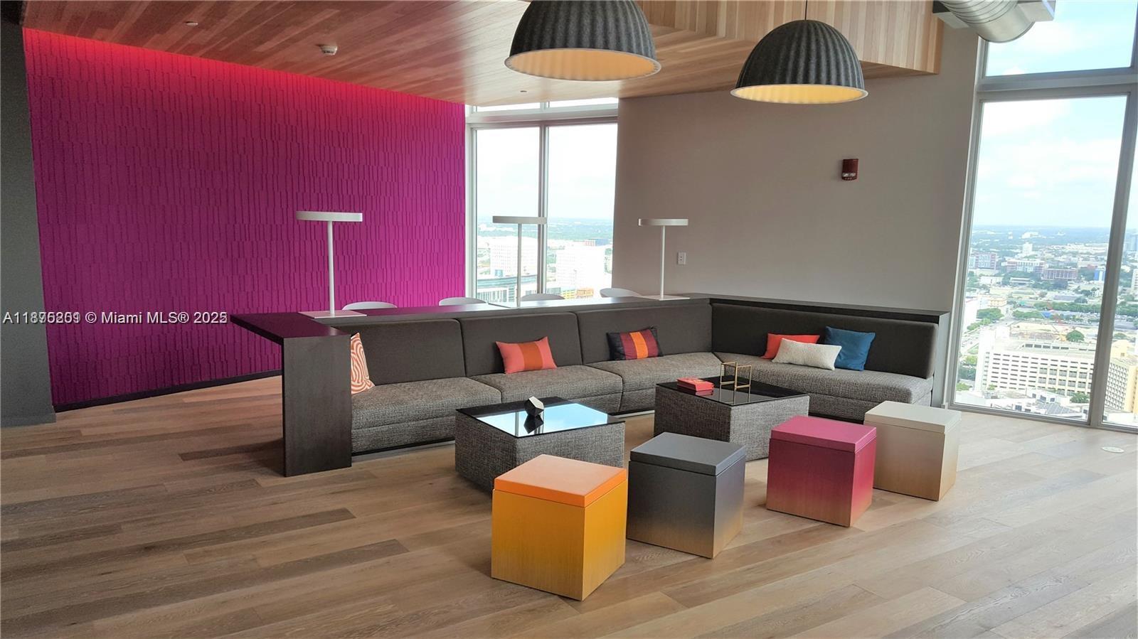 151 Southeast 1st Street, Unit 2807 Miami, FL 33131 - Photo 20 of 24 a living room with furniture and wooden floor