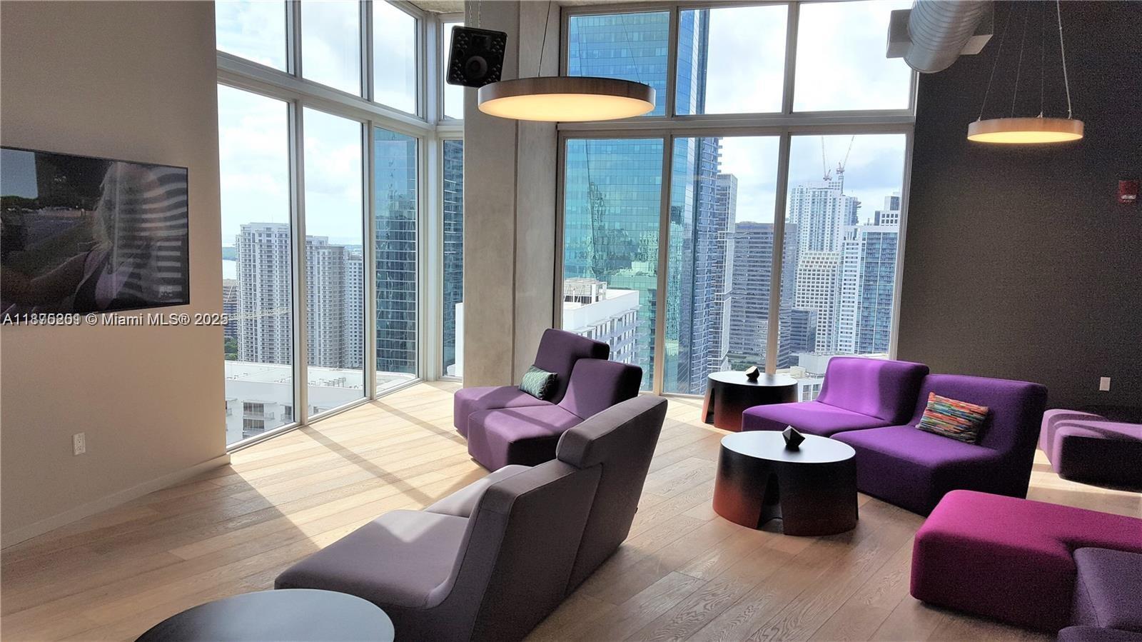 151 Southeast 1st Street, Unit 2807 Miami, FL 33131 - Photo 21 of 24 a living room with furniture and a floor to ceiling window