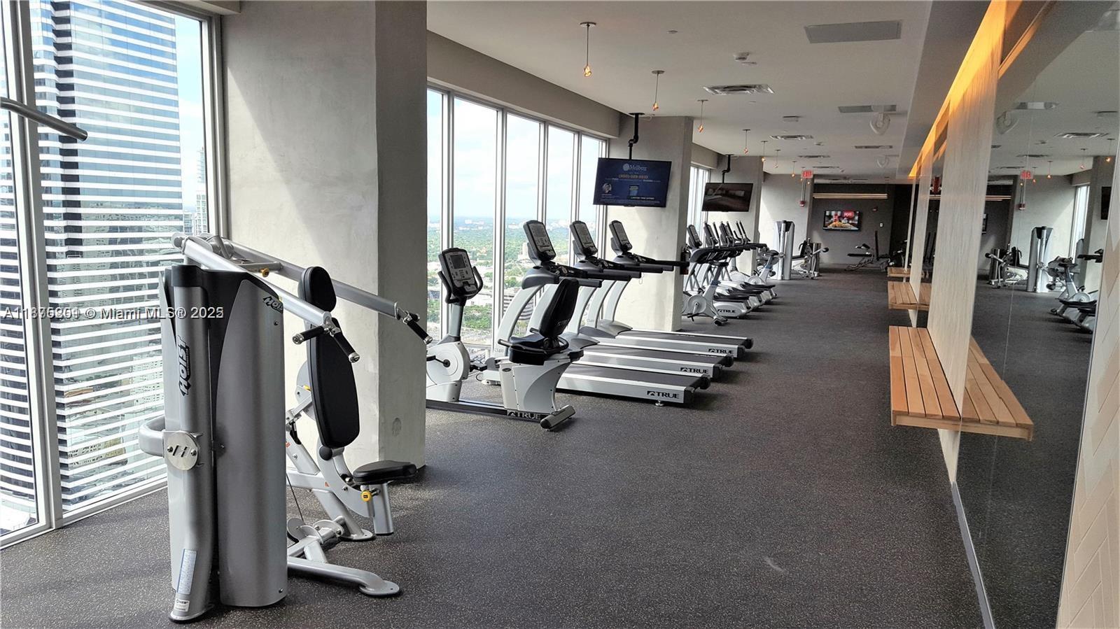151 Southeast 1st Street, Unit 2807 Miami, FL 33131 - Photo 22 of 24 a view of a room with gym equipment