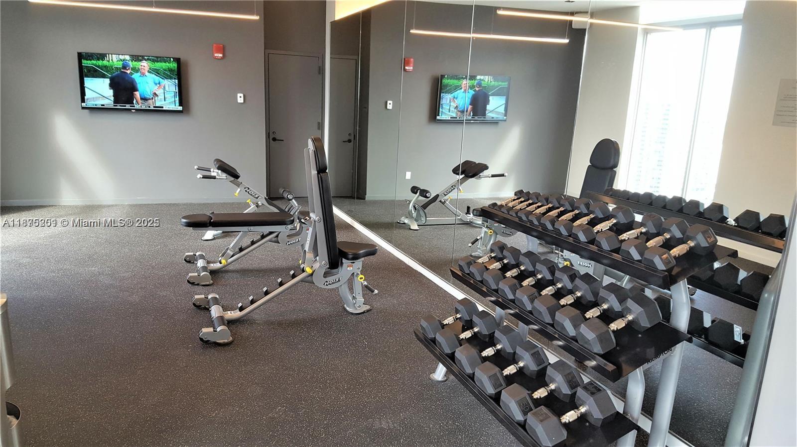 151 Southeast 1st Street, Unit 2807 Miami, FL 33131 - Photo 23 of 24 a room with gym equipment