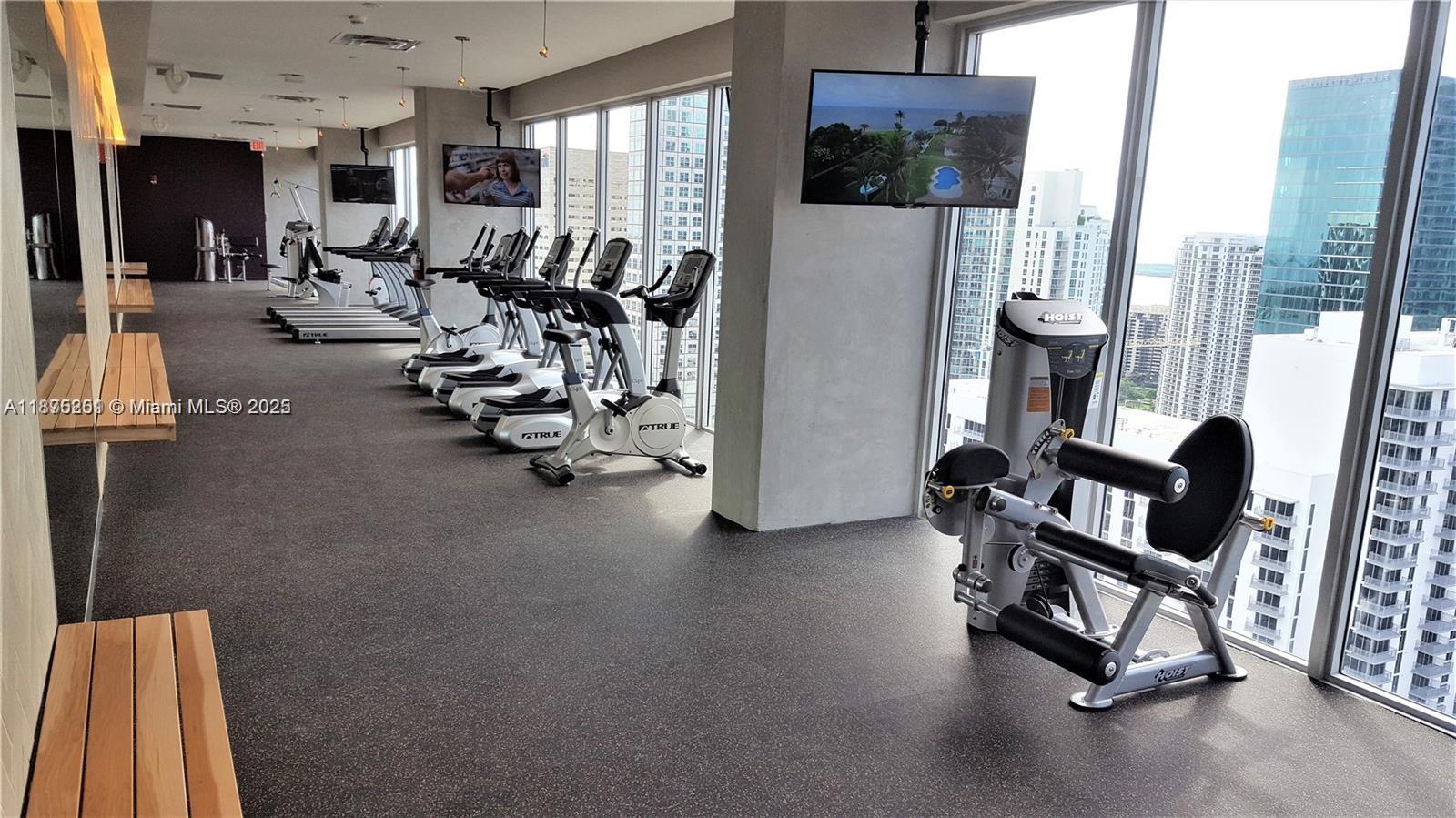 151 Southeast 1st Street, Unit 2807 Miami, FL 33131 - Photo 24 of 24 a view of a room with gym equipment