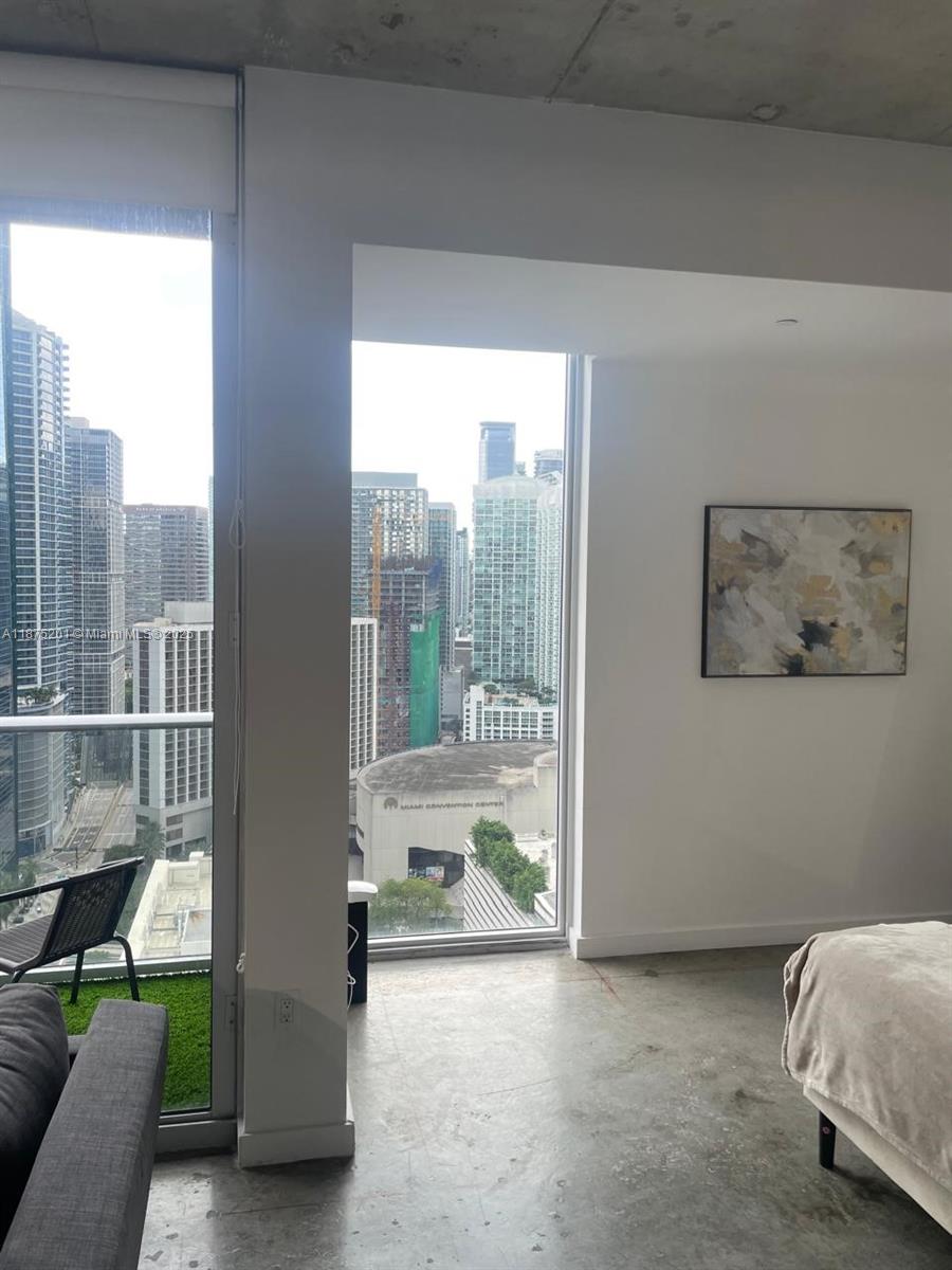 151 Southeast 1st Street, Unit 2807 Miami, FL 33131 - Photo 6 of 24 a view of a room with a balcony and furniture