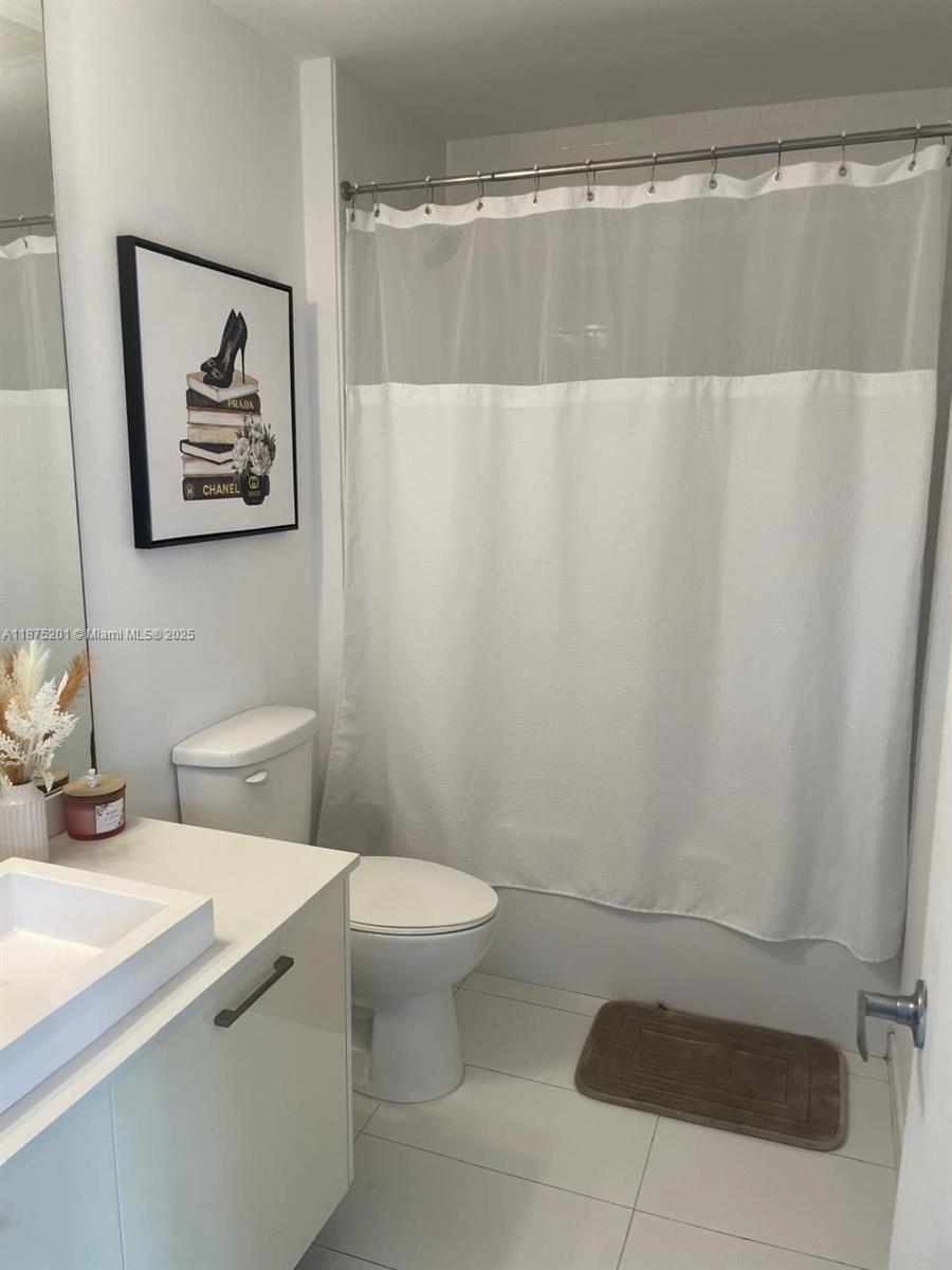 151 Southeast 1st Street, Unit 2807 Miami, FL 33131 - Photo 8 of 24 a bathroom with a sink and a mirror