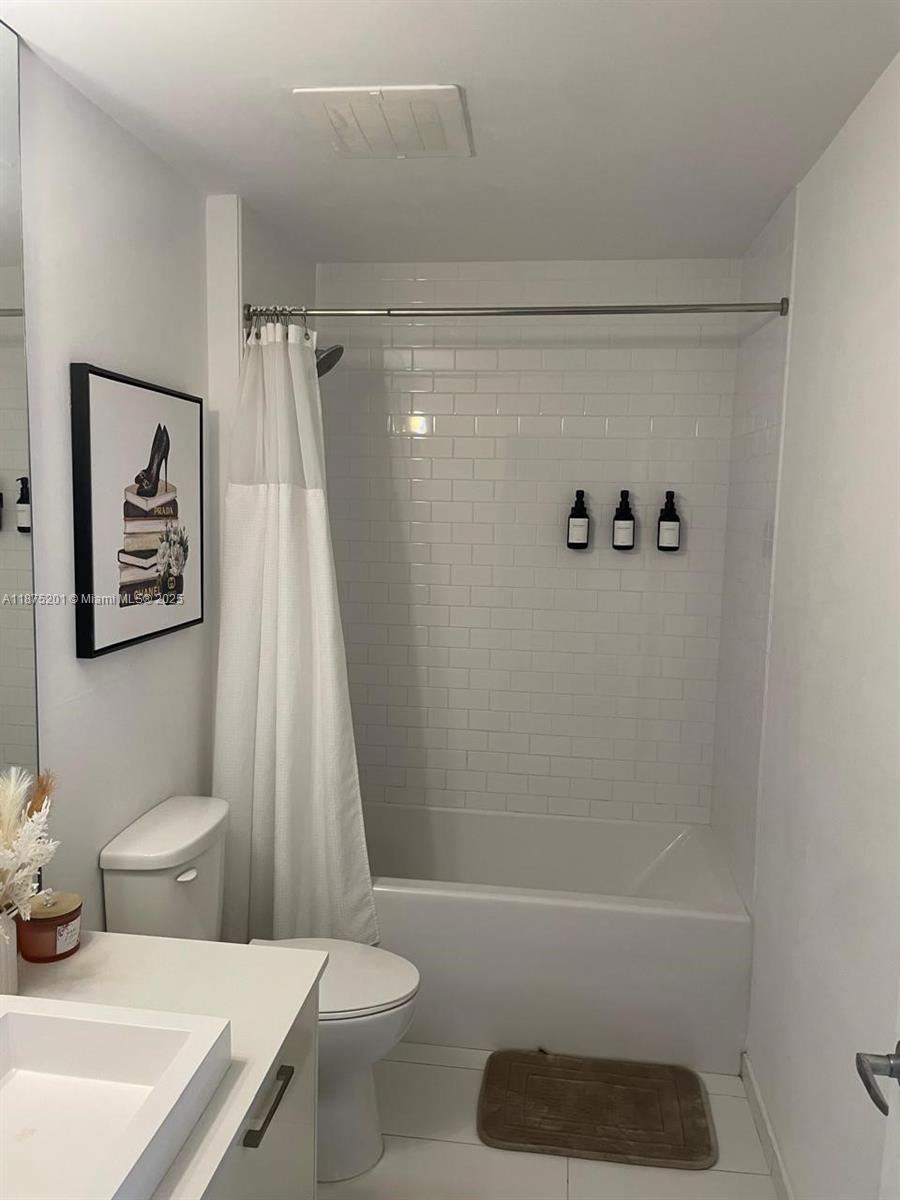 151 Southeast 1st Street, Unit 2807 Miami, FL 33131 - Photo 9 of 24 a bathroom with a shower a toilet and a sink