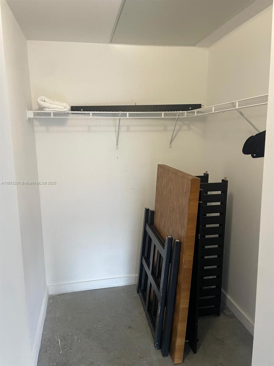 151 Southeast 1st Street, Unit 2807 Miami, FL 33131 - Photo 10 of 24 a view of walk in closet with empty racks