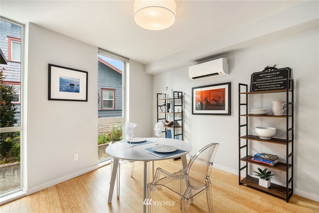 983 North 45th Street Seattle, WA 98103 - Photo 13 of 32 a view of a dining room with furniture and wooden floor