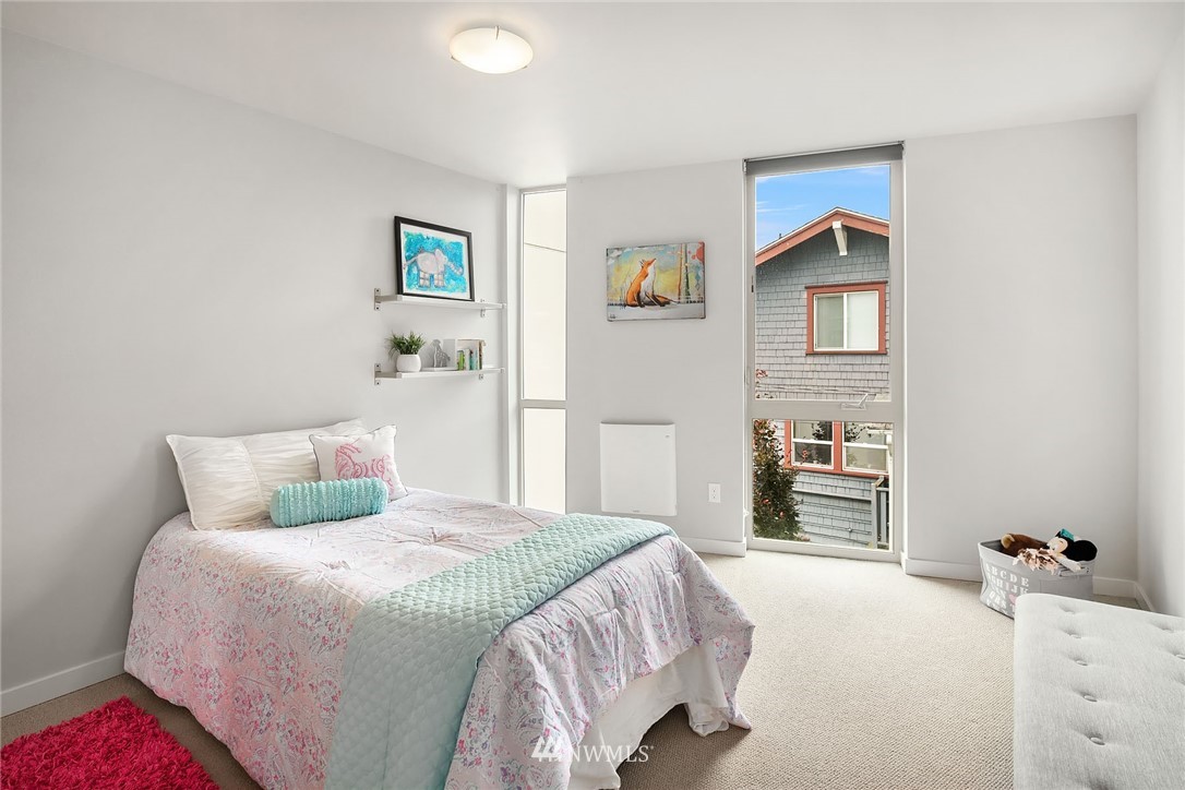 983 North 45th Street Seattle, WA 98103 - Photo 17 of 32 a bedroom with a bed and a table