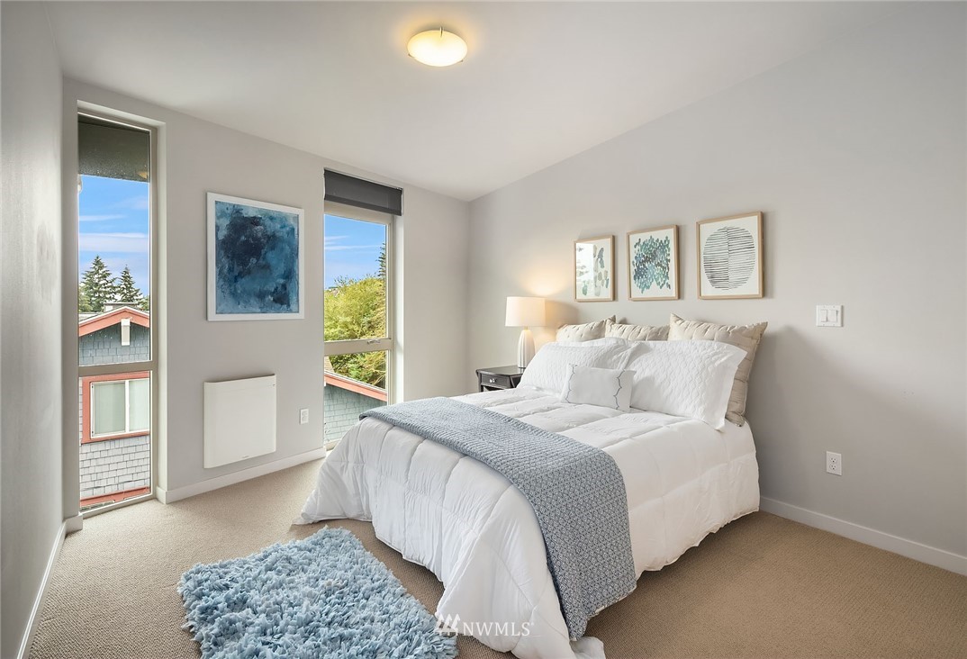 983 North 45th Street Seattle, WA 98103 - Photo 20 of 32 a bedroom with a bed and a window