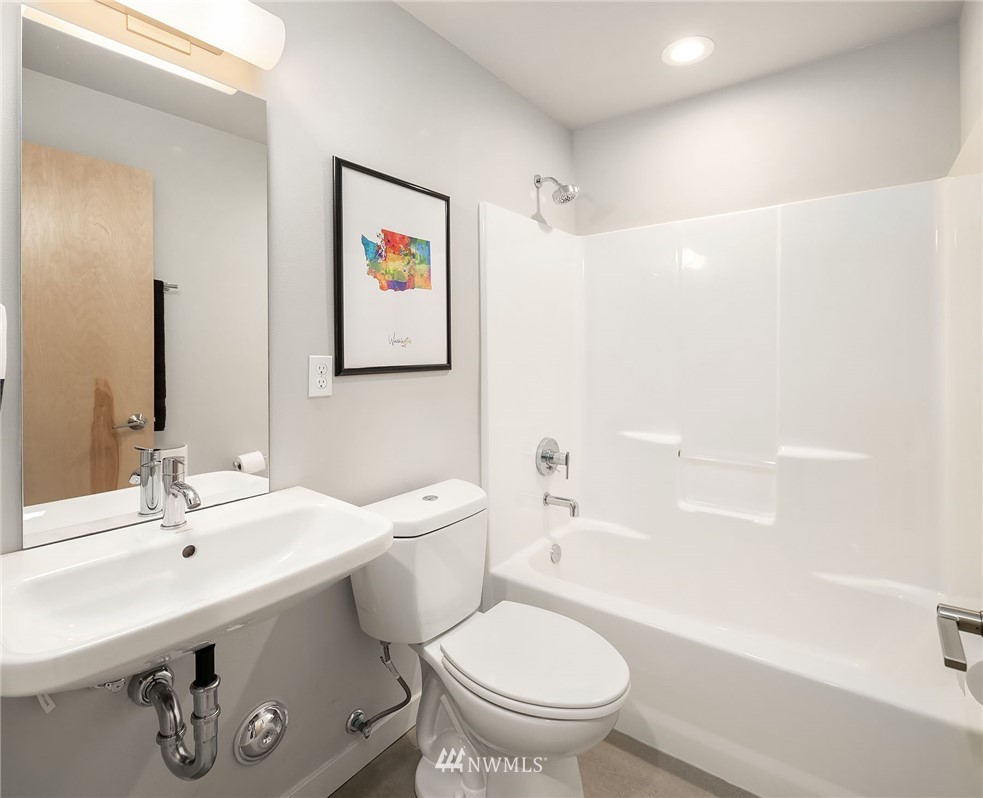 983 North 45th Street Seattle, WA 98103 - Photo 29 of 32 a bathroom with a sink and a mirror