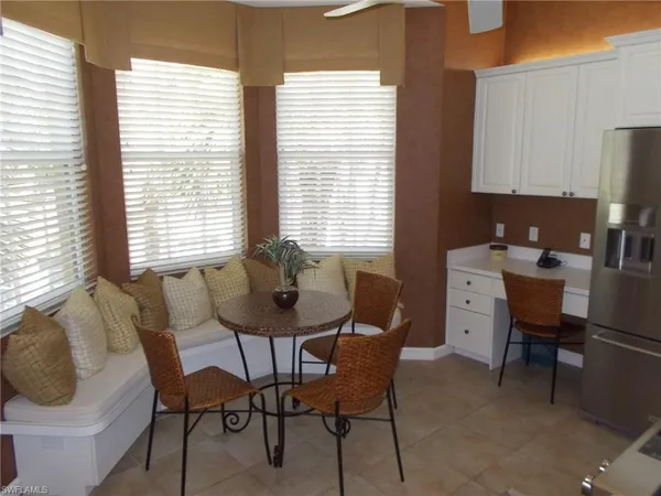 a dining room with furniture and window