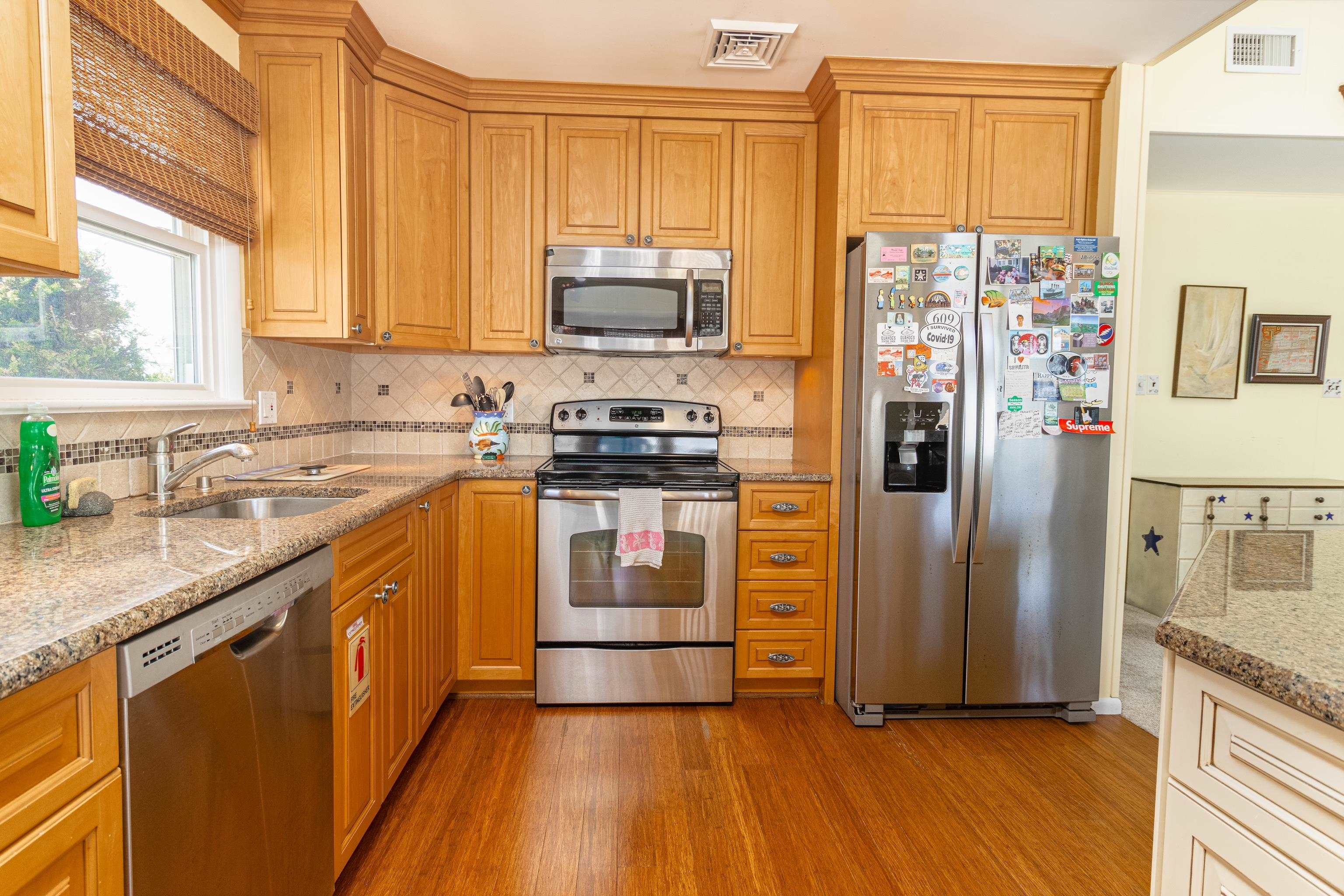 181 7th Street Avalon, NJ 08202 - Photo 13 of 29 a kitchen with stainless steel appliances granite countertop a refrigerator stove and sink