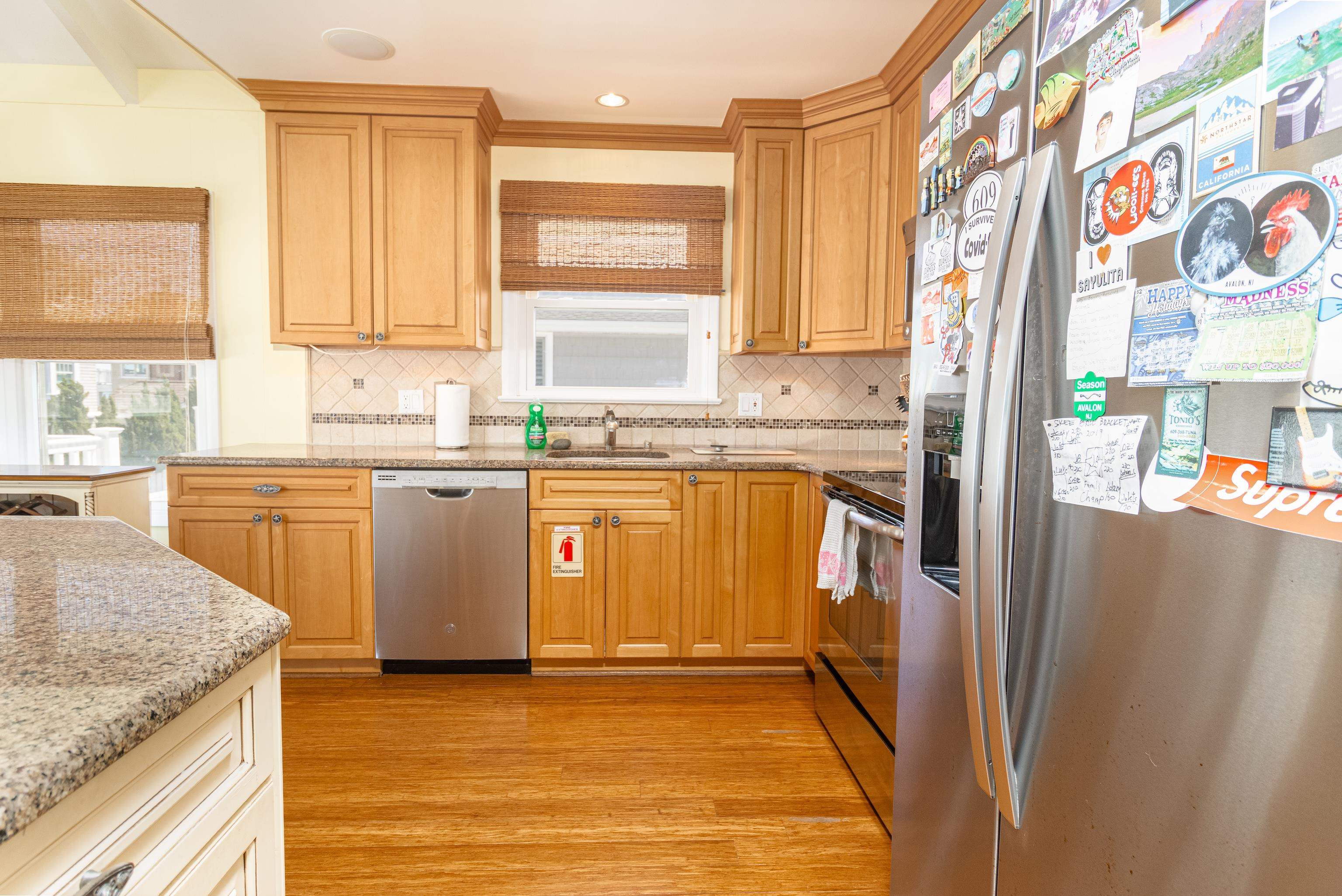 181 7th Street Avalon, NJ 08202 - Photo 14 of 29 a kitchen with stainless steel appliances granite countertop a stove a sink and a refrigerator